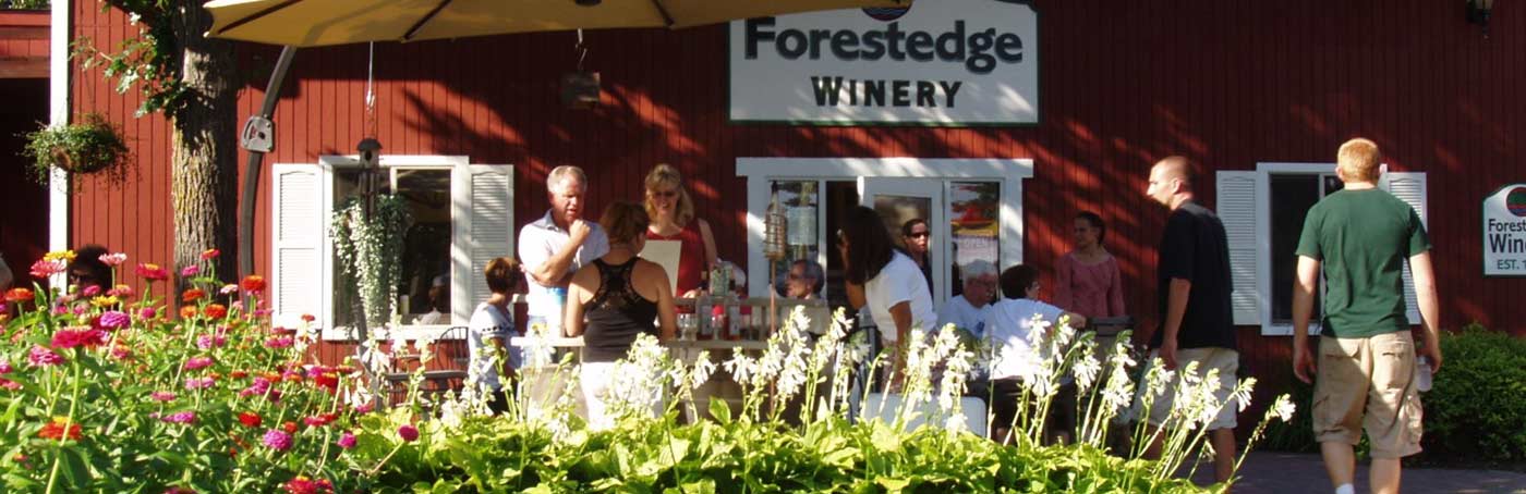 a group of people visiting outside of a winery