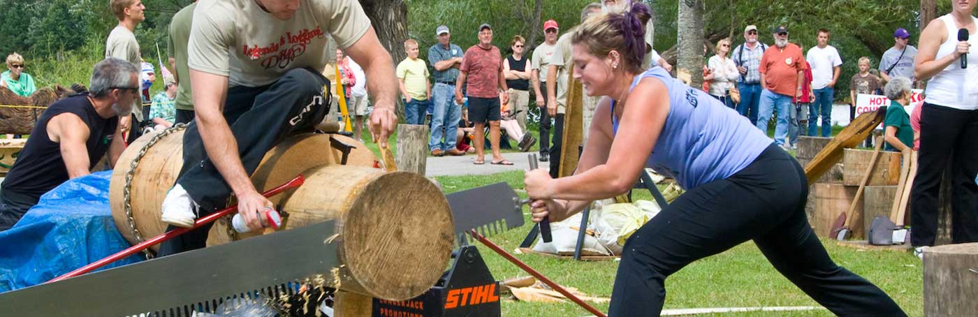 woman competing in a log sawing competition